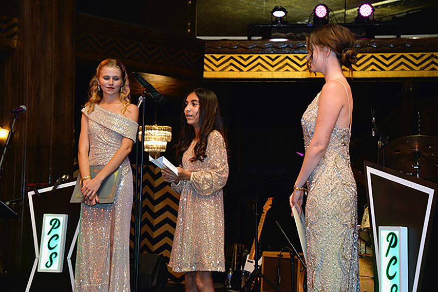 Hailey Newburry, AotF with Alina Vizcara, accepting the "Woman in Philanthropy" award, and Alexandra Gill, AotF